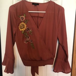 Burnt orange top with embroidered flowers